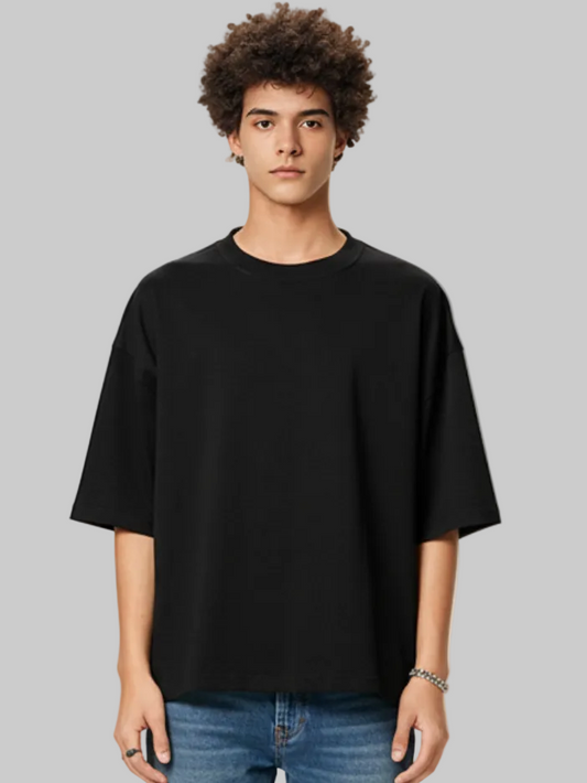 Person wearing a black t-shirt against a plain background