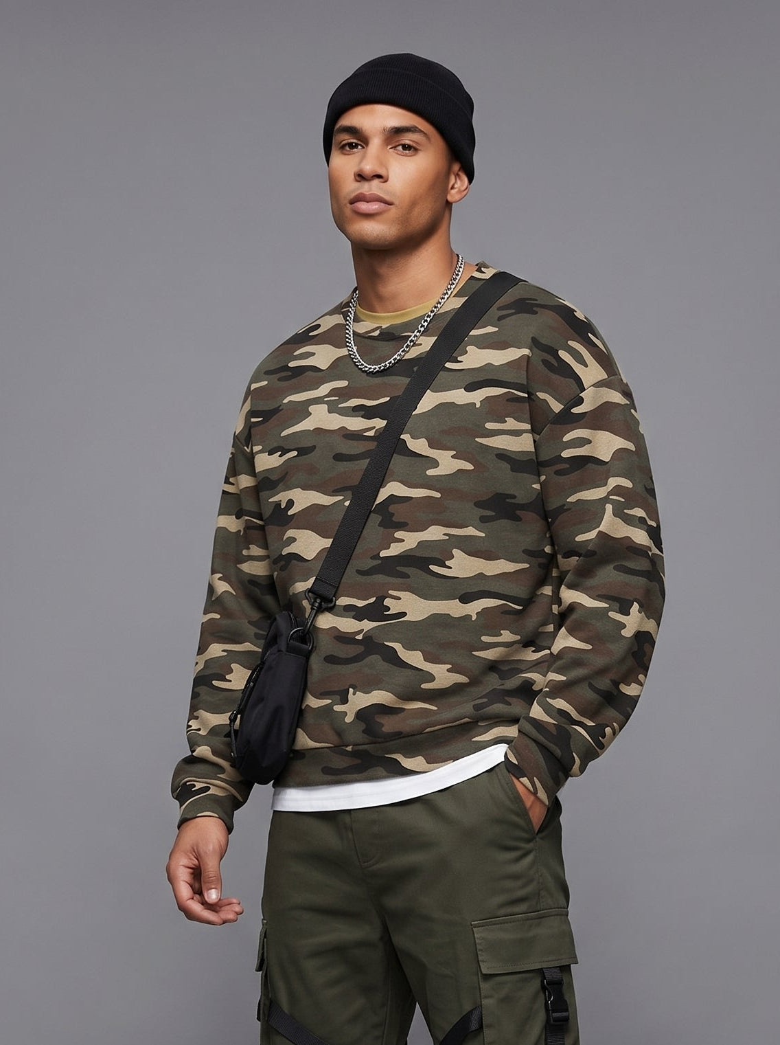 Camo print oversized crewneck sweatshirt by Apollo Moda, worn with green cargo pants on a grey background