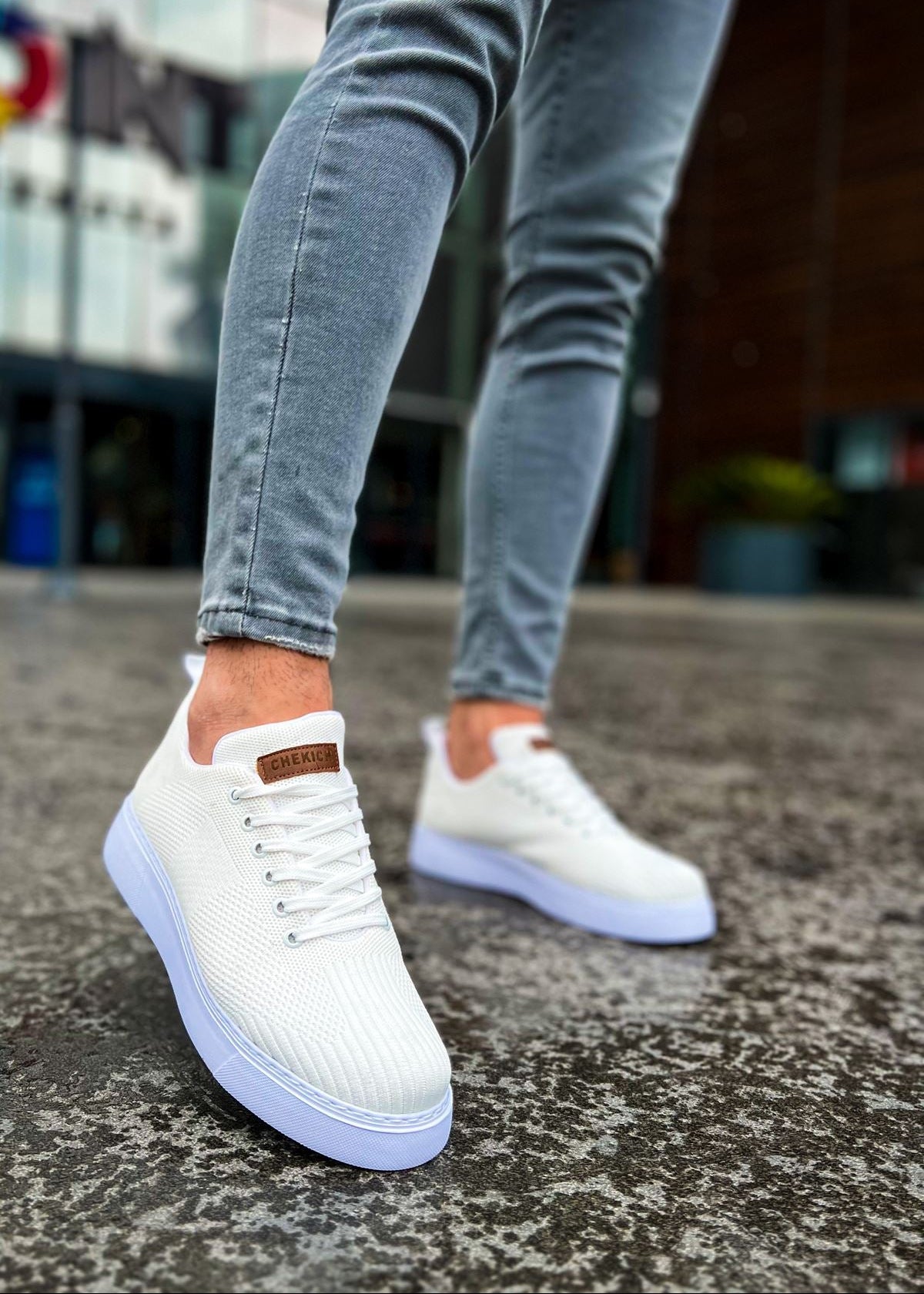 Kotor Pure Serenity knitted lace-up sneaker in white by Apollo Moda, worn on concrete