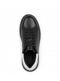 Black leather sneaker with white sole on a white background