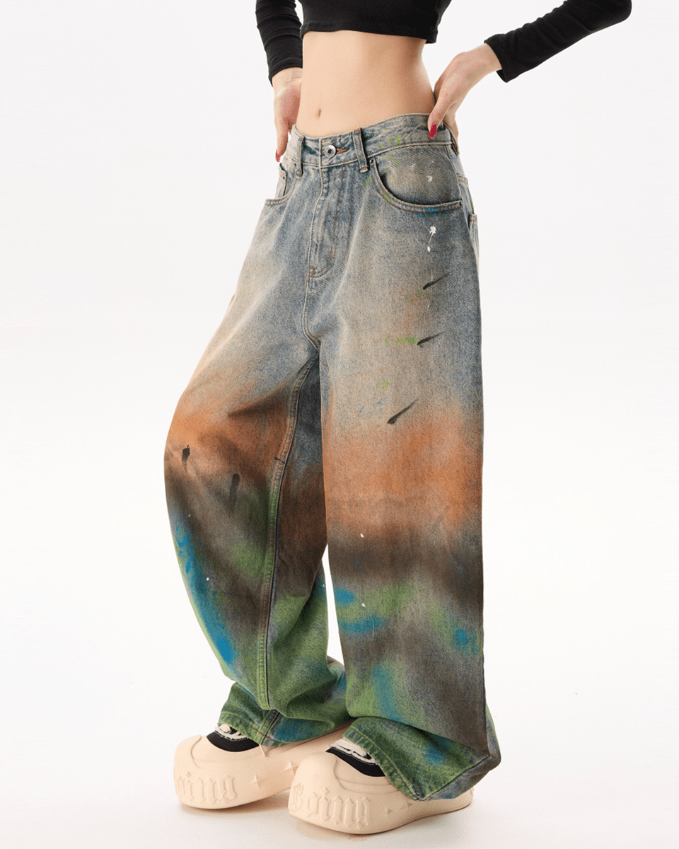 Tie-dye jeans with a gradient effect worn by a person on a white background