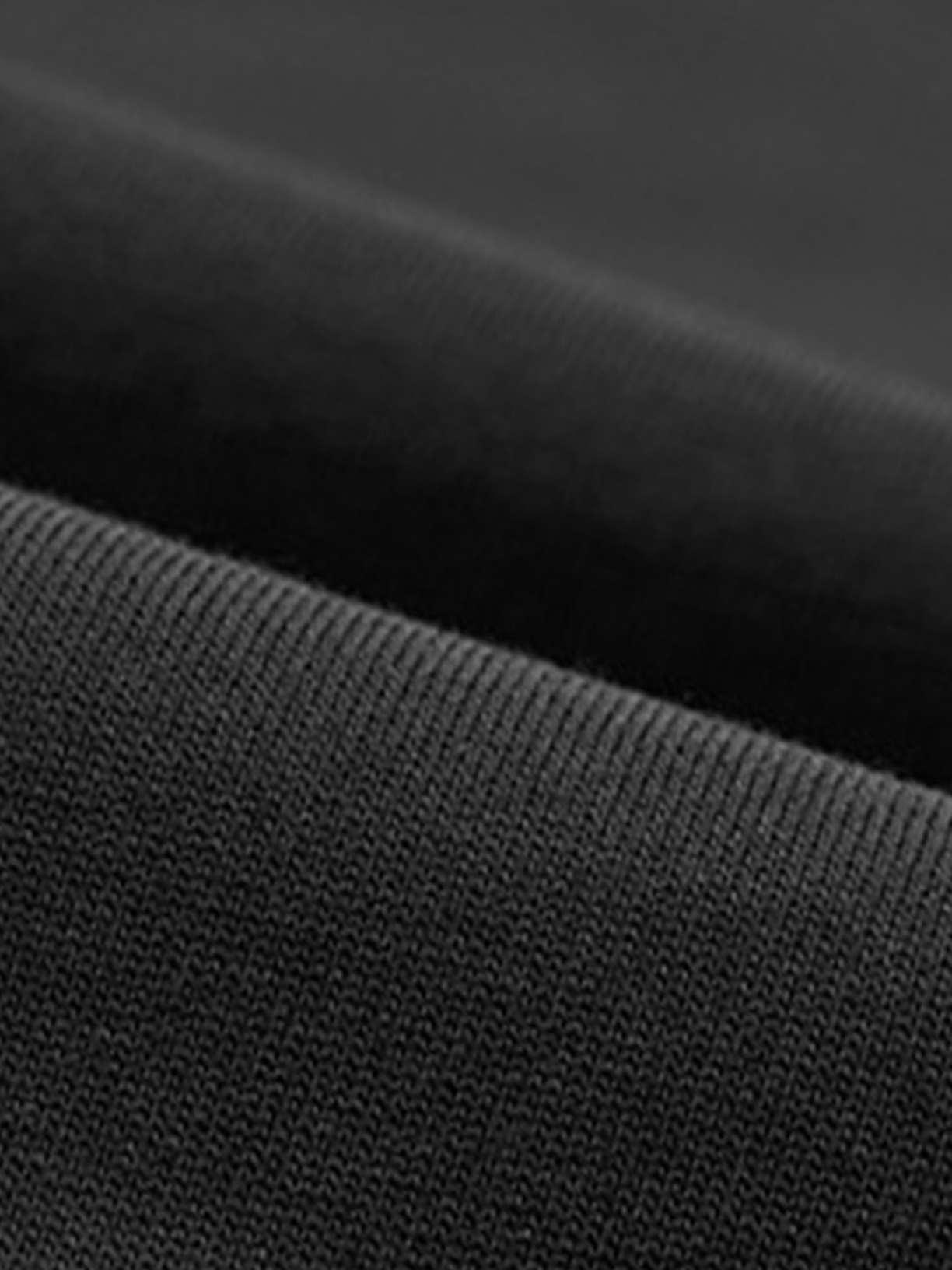 Aero boxy crop tee in black by Apollo Moda, close-up of the cotton fabric texture